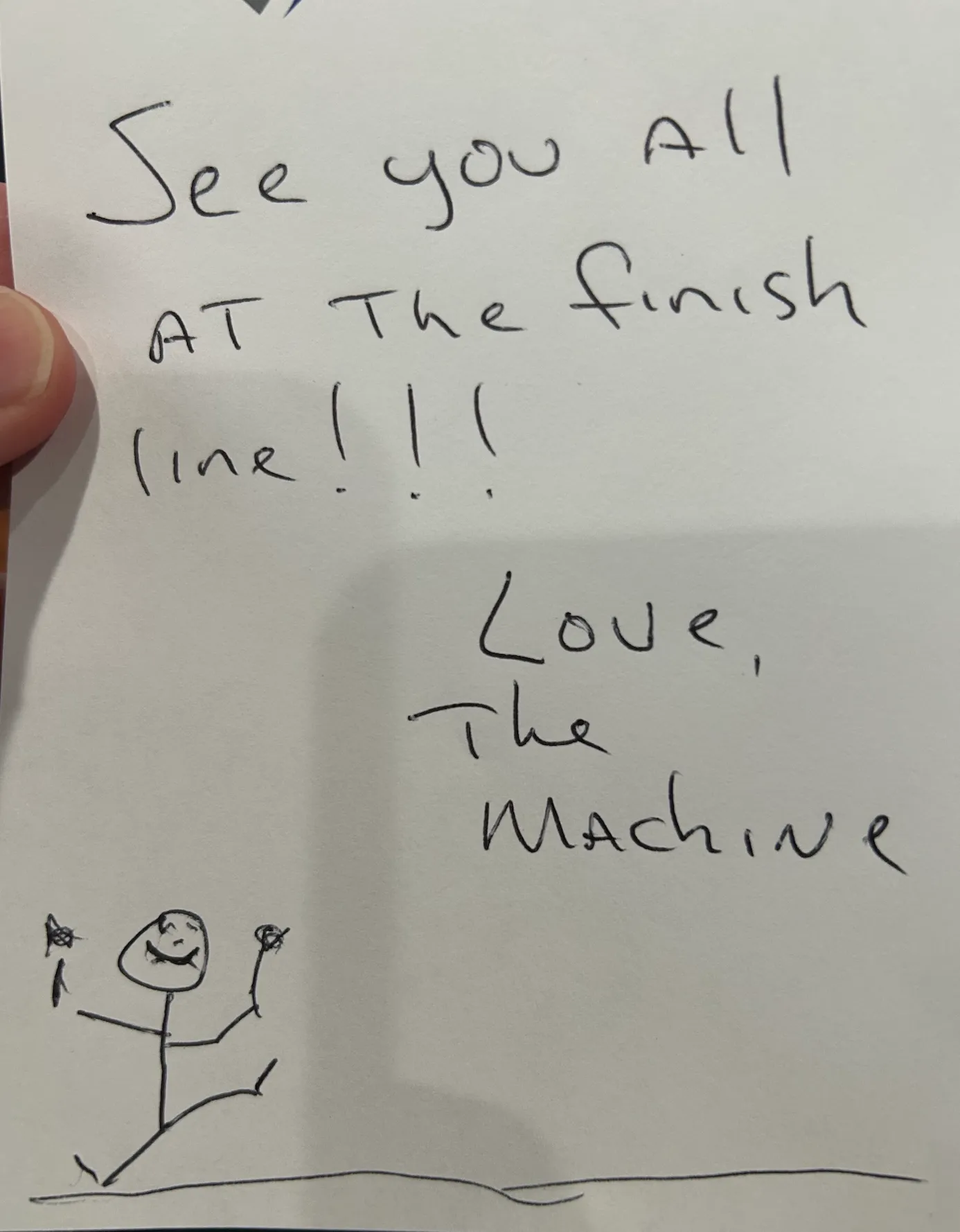 A handwritten note reading 'See you all at the finish line!!! Love, The Machine' with a stick figure drawing